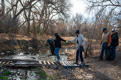 Volunteers crossing the Santa Cruz River for the river clean up.